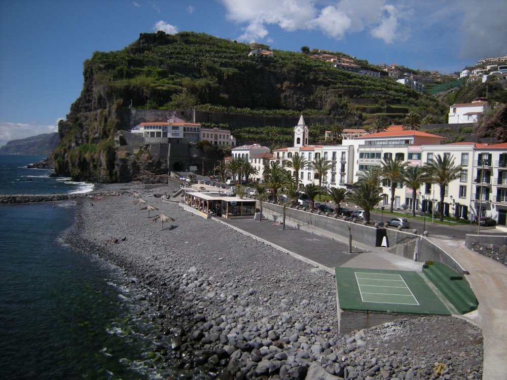 Ponta do Sol’s waterfront with red-roofed buildings below green hills